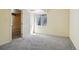 View of the carpeted basement highlighting a window, doorway, and a neutral color palette at 882 W 96Th Ave, Thornton, CO 80260