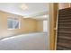 Spacious carpeted basement with a window and access to another room, offering versatile living space at 882 W 96Th Ave, Thornton, CO 80260