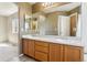 The bathroom features a dual sink vanity, large mirror and arched ceiling at 882 W 96Th Ave, Thornton, CO 80260