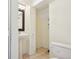 A bathroom featuring pedestal sink, toilet, tile flooring and a dark framed mirror at 882 W 96Th Ave, Thornton, CO 80260