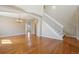 Open entryway featuring gleaming hardwood floors, a staircase with white risers, and arched doorways at 882 W 96Th Ave, Thornton, CO 80260