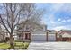 Charming two-story home with a manicured lawn, red door, and a spacious three-car garage at 882 W 96Th Ave, Thornton, CO 80260