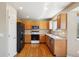 Bright kitchen with hardwood floors, wood cabinets, granite countertops, and stainless-steel appliances at 882 W 96Th Ave, Thornton, CO 80260