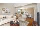 Bright living room with hardwood floors, neutral decor, and an open archway into the dining area at 882 W 96Th Ave, Thornton, CO 80260