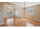 Bright and airy living room with hardwood floors, stylish lighting, and large windows at 882 W 96Th Ave, Thornton, CO 80260