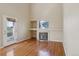 Bright living room featuring hardwood floors, a fireplace, built-in shelves, and a glass door to the outside at 882 W 96Th Ave, Thornton, CO 80260