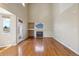 Spacious living room featuring hardwood floors, a fireplace, built-in shelving, and ample natural light at 882 W 96Th Ave, Thornton, CO 80260