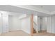Finished basement with neutral walls, modern flooring, and a staircase, providing a versatile space at 2276 Newland St, Edgewater, CO 80214