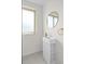 Compact bathroom featuring a sink with an integrated cabinet, a gold mirror, and fixtures at 2276 Newland St, Edgewater, CO 80214