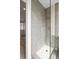 Tiled walk-in shower with a glass enclosure and a rainfall showerhead, offering a luxurious bathing experience at 2276 Newland St, Edgewater, CO 80214