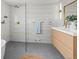 Modern bathroom features a glass enclosed shower, gold fixtures, and floating vanity with a white countertop at 2276 Newland St, Edgewater, CO 80214