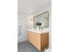 Beautiful bathroom showcasing a wood vanity with gold fixtures, decorative lighting, and neutral color palette at 2276 Newland St, Edgewater, CO 80214