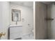 Modern bathroom featuring shower with gray tile and vanity with gold hardware at 2276 Newland St, Edgewater, CO 80214