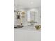 Bright kitchen featuring floating shelves, modern countertops, stylish backsplash, and stainless steel hood at 2276 Newland St, Edgewater, CO 80214