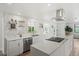 Bright and open kitchen featuring a large island, modern appliances, and sleek countertops at 2276 Newland St, Edgewater, CO 80214