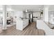 Spacious kitchen featuring an island, stainless steel appliances, and sleek white cabinetry at 2276 Newland St, Edgewater, CO 80214