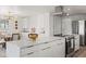 Contemporary kitchen with a large island, stainless steel appliances, and modern lighting at 2276 Newland St, Edgewater, CO 80214