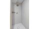 Contemporary shower features gray tiling, gold fixtures, and unique shower head at 2276 Newland St, Edgewater, CO 80214