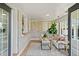 Bright and airy sunroom featuring neutral decor, brick accents, and lots of windows at 2276 Newland St, Edgewater, CO 80214