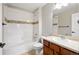 Bathroom with tiled tub and shower, decorative accent tile, and vanity with sink at 13524 Via Varra, Broomfield, CO 80020