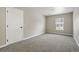 Empty bedroom with neutral carpet, a window, and a door at 13524 Via Varra, Broomfield, CO 80020