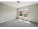 Bright bedroom with neutral carpet and a large window offering natural light at 13524 Via Varra, Broomfield, CO 80020