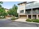 Modern townhome exterior showcasing stone accents, a balcony, and an attached garage at 13524 Via Varra, Broomfield, CO 80020