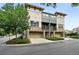 Street view of multi-story townhomes with stone accents and attached garages at 13524 Via Varra, Broomfield, CO 80020