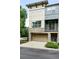 Modern townhome with stone accents, garage, balcony, and neutral two-tone paint at 13524 Via Varra, Broomfield, CO 80020
