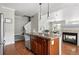 Kitchen island has granite countertops, sink, wood cabinets and is open to the living spaces at 13524 Via Varra, Broomfield, CO 80020
