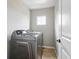 Laundry room with side-by-side washer and dryer and tile floor at 13524 Via Varra, Broomfield, CO 80020