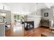 Spacious living room with hardwood floors, fireplace, built-in countertop, and large windows at 13524 Via Varra, Broomfield, CO 80020