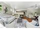 Open-concept living room featuring a fireplace, hardwood floors, and modern decor at 13524 Via Varra, Broomfield, CO 80020