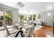 Bright living room features large windows, wood floors, comfortable seating and access to the balcony at 13524 Via Varra, Broomfield, CO 80020