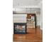 Open-concept living room featuring a fireplace and hardwood floors, leading into a modern kitchen area at 13524 Via Varra, Broomfield, CO 80020