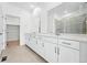 Bathroom boasts double sinks, a large mirror, and stylish cabinets providing ample storage space at 3438 N Duquesne Way, Aurora, CO 80019