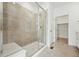 Walk-in shower featuring modern tile, built in bench and sleek glass door at 3438 N Duquesne Way, Aurora, CO 80019