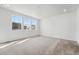 Spacious bedroom with plush carpeting and plenty of natural light from the three large windows at 3438 N Duquesne Way, Aurora, CO 80019