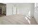 Bright bedroom with neutral carpeting, open doorway, and ample sunlight at 3438 N Duquesne Way, Aurora, CO 80019
