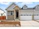 Charming townhome with a mix of stone and siding, complemented by a well-kept lawn and attached two-car garage at 3438 N Duquesne Way, Aurora, CO 80019