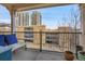 Balcony with relaxing outdoor seating offering views of city buildings and nearby garage at 3000 E 16Th Ave # 320, Denver, CO 80206