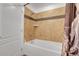 Bathroom with a shower-tub and tiled walls at 3000 E 16Th Ave # 320, Denver, CO 80206