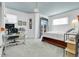 Bedroom featuring a bed, a desk, a door to a balcony, and a large window for natural light at 3000 E 16Th Ave # 320, Denver, CO 80206