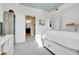 Bright bedroom with a blue ceiling, gray carpet, and two doors leading to a bathroom and a closet at 3000 E 16Th Ave # 320, Denver, CO 80206
