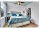 Cozy bedroom with a comfortable bed, nightstands, and a large window with natural light at 3000 E 16Th Ave # 320, Denver, CO 80206