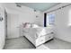 Bright bedroom with a blue ceiling, gray carpet, white walls, and two windows for natural light at 3000 E 16Th Ave # 320, Denver, CO 80206