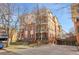 A charming brick condo building with tan siding and an underground parking garage at 3000 E 16Th Ave # 320, Denver, CO 80206