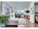 Open-concept living room with a fireplace, large windows, and hardwood floors at 3000 E 16Th Ave # 320, Denver, CO 80206