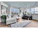 Bright living room featuring a comfortable sofa, large windows, and an area rug at 3000 E 16Th Ave # 320, Denver, CO 80206