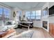 Bright living room with fireplace, large windows, dining table and hardwood floors at 3000 E 16Th Ave # 320, Denver, CO 80206